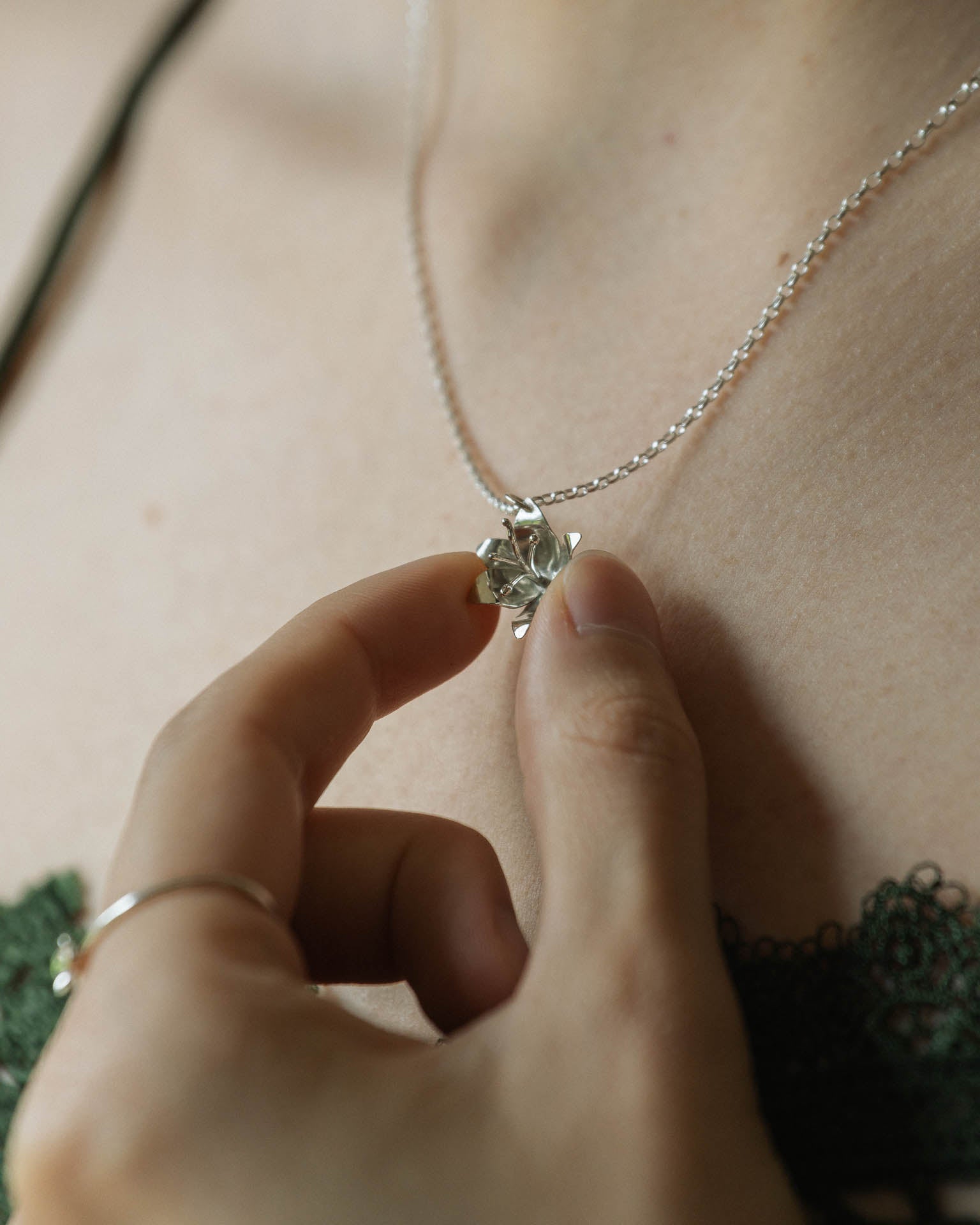 a small lily flower pendant in silver