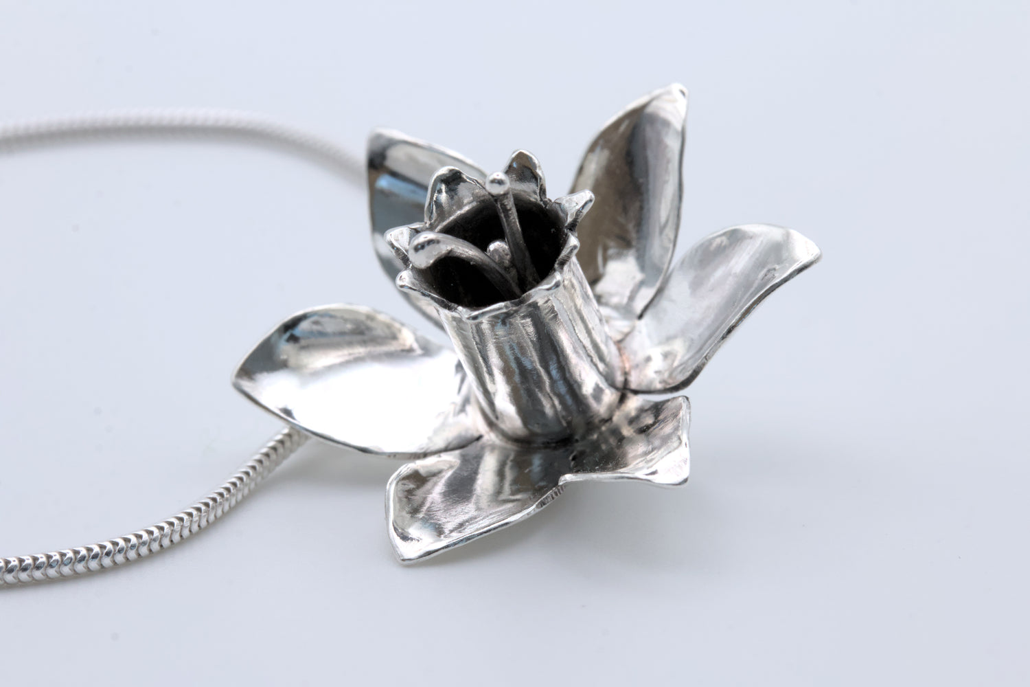 a statement, handcrafted, silver daffodil pendant