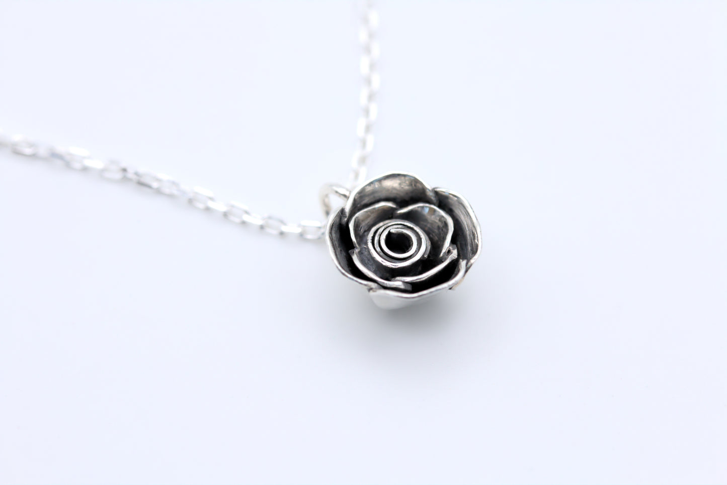 A handcrafted silver rose pendant