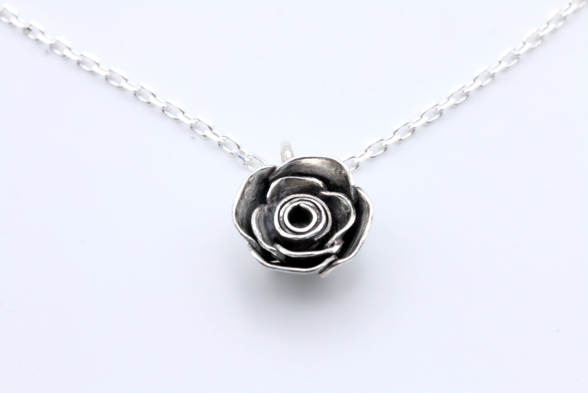 A handcrafted silver rose pendant