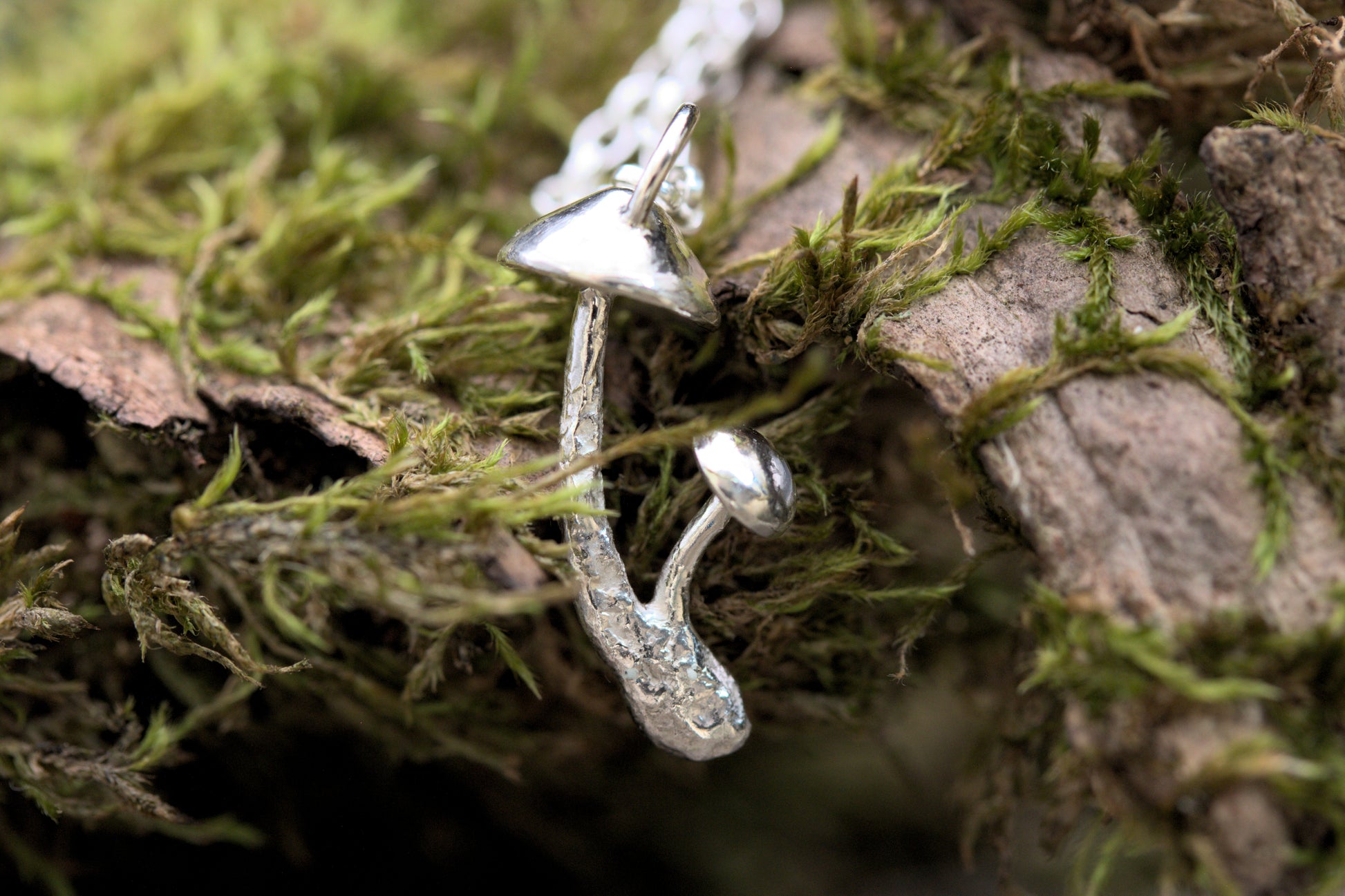 A handcrafted silver fungi pendant