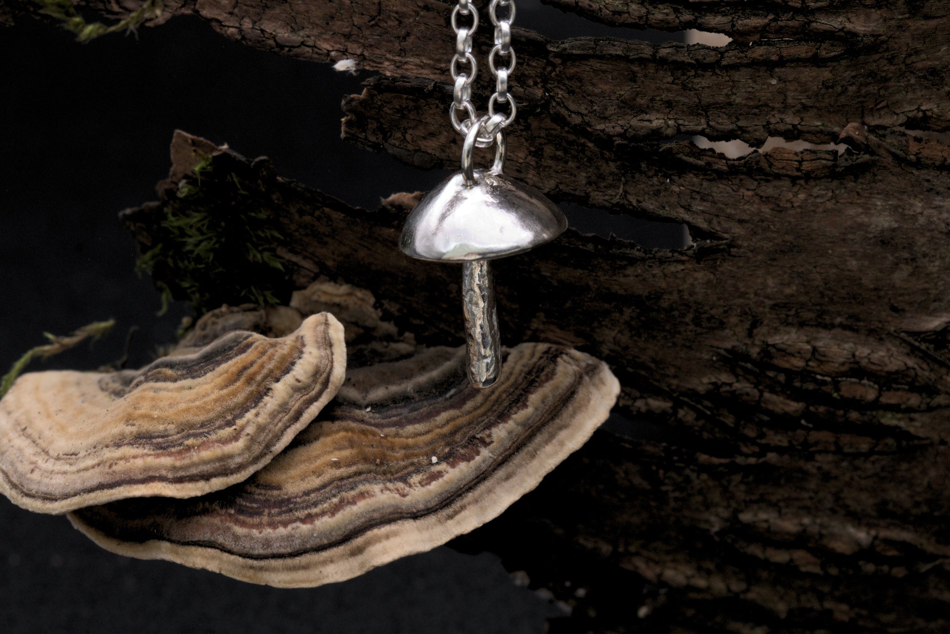 A handcrafted silver fungi pendant