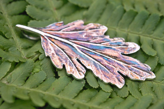 A fine silver leaf pendant with colourful patina