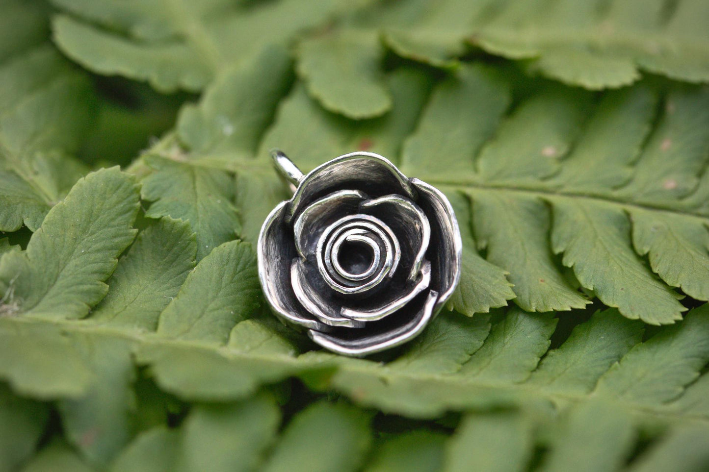 A handcrafted silver rose pendant