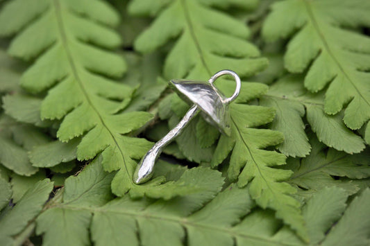 A handcrafted silver fungi pendant