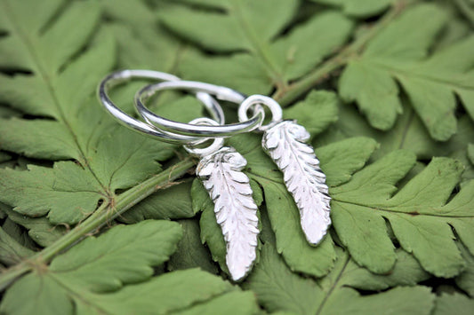 a tiny pair of fern leaf hoop earrings in silver